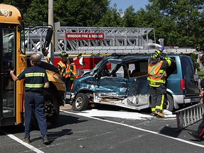 Windsor firefighters, Windsor Police and Essex-Windsor EMS paramedics at the scene of a collision involving a school bus and a GMC van on Huron Church Road at Malden Road August 11, 2015. Three were sent to hospital, non life threatening injuries, and northbound traffic was a mess until the wreck could be towed away. (NICK BRANCACCIO/The Windsor Star)