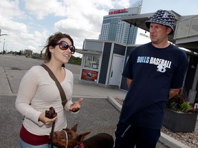Cheryl, left, and Jason Sorn and their pet, Justice, discuss their visit the Windsor, which had little to do with the strong U.S. dollar,  August 20, 2015.  The Sorns are from New Hudson, Michigan.  (NICK BRANCACCIO/The Windsor Star)