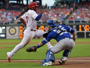 Russell Martin #55 of the Toronto Blue Jays loses the ball trying to tag Odubel Herrera #37 of the Philadelphia Phillies in the first inning at Citizens Bank Park on August 19, 2015 in Philadelphia, Pennsylvania.  (Photo by Drew Hallowell/Getty Images)