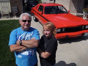 Pete and Lynn Mosceo are concerned after being told by plaza security they are not wanted during last Wednesday's cruise night on Manning Road.  In photo, Pete and Lynn pose with their 1980 Plymouth Volare equipped with a 318 cid V8 engine and a flawless, Hemi Orange paint job Friday, Aug. 21, 2015. (NICK BRANCACCIO/The Windsor Star)