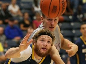 University of Windsor guard, Mitch Farrell and University of Indianapolis Andrej Slavik battle for a loose basketball during men's basketball action at the St. Denis Centre in Windsor, Ontario on August 20, 2015. (JASON KRYK/The Windsor Star)