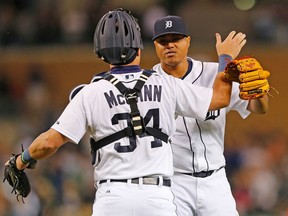 Alfredo Simon #31 and James McCann #34 of the Detroit Tigers celebrate a win over the Texas Rangers on August 20, 2015 at Comerica Park in Detroit, Michigan. The Tigers defeated the Rangers 4-0. (Photo by Leon Halip/Getty Images)