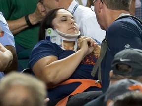 A fan is carried out by medics after getting hit in the side of her head by a foul ball in the eighth inning during a MLB game between the Detroit Tigers and the Texas Rangers at Comerica Park on August 21, 2015 in Detroit, Michigan.(Photo by Dave Reginek/Getty Images)