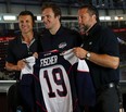 Christian Fischer, centre, is given a Spitfires Jersey by head coach Rocky Thompson, left, and GM Warren Rychel during a press conference at the WFCU Centre in Windsor on Monday, August 24, 2015. (TYLER BROWNBRIDGE/The Windsor Star)