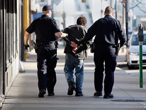 In this file photo, Windsor police arrest a man on the Chatham Street sidewalk at Ouellette Avenue following an altercation in November 2010. No charges were laid against the man and he was taken to hospital under the Mental Health Act. (NICK BRANCACCIO/The Windsor Star)