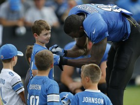 Detroit Lions wide receiver Calvin Johnson signs autographs after practice in Allen Park, Mich. (AP Photo/Paul Sancya)