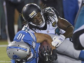 Detroit Lions wide receiver Corey Fuller (10) catches a pass for a 4-yard touchdown as Jacksonville Jaguars defensive back Davon House, right, comes in for the tackle during the first half of an NFL preseason football game in Jacksonville, Fla., Friday, Aug. 28, 2015.(AP Photo/Phelan M. Ebenhack)