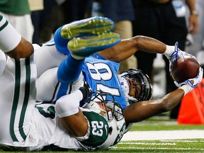 Detroit Lions wide receiver Ryan Broyles pulls in a pass while defended by New York Jets cornerback Dexter McDougle (23) during the first half of an NFL preseason football game, Thursday, Aug. 13, 2015, in Detroit. (AP Photo/Paul Sancya)