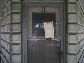 A bylaw notice is posted on the door of a vacant home at 1404 Tecumseh Rd. West, Saturday, August 1, 2015.   (DAX MELMER/The Windsor Star)