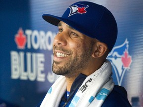 Toronto Blue Jays newly acquired starting pitcher David Price smiles in the dugout as his team plays against the Kansas City Royals during second inning AL baseball action in Toronto on Friday, July 31, 2015. THE CANADIAN PRESS/Fred Thornhill