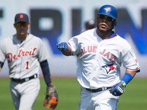 Toronto Blue Jays Edwin Encarnacion (right) rounds the bases after hitting a solo home run off Detroit Tigers starting pitcher Alfredo Simon as Tigers' shortstop Jose Iglesias (left) looks on during first inning Major League baseball action in Toronto on Sunday, August 30 , 2015. The Blue Jays and Tigers may encounter each other in this year's playoffs.