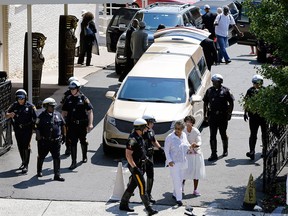 People walk from a service for Bobbi Kristina Brown at Whigham funeral home in Newark, N.J., early Monday, Aug. 3, 2015. Bobbi Kristina, the only child of Whitney Houston and R&B singer Bobby Brown, died in hospice care July 26, about six months after she was found face-down and unresponsive in a bathtub in her suburban Atlanta home. (AP Photo/Mel Evans)