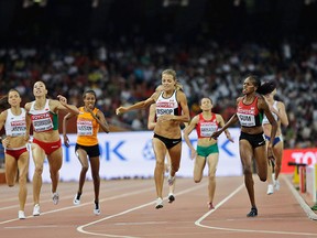 Belarus' Marina Arzamasova, left, Canada's Melissa Bishop, middle, and Kenya's Eunice Jepkoech Sum compete in a women's 800m semifinal at the World Athletics Championships at the Bird's Nest stadium in Beijing, Thursday, Aug. 27, 2015. (AP Photo/David J. Phillip)