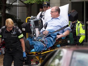 Windsor Mayor Drew Dilkens is removed from 400 City Hall Square by paramedics after he experienced a dizzy spell on Thursday, Aug. 27, 2015. (DAX MELMER/The Windsor Star)