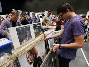 Comic book fans check out the wide selection of posters at the 2015 edition of Windsor ComiCon.