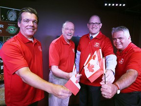 Marty Beneteau (left) and Mayor Drew Dilkens (second from right) are presented with Flag Project t-shirts by Michael Beale and Peter Hrastovec (right) at the Windsor Star News Cafe for their contributions to the project in Windsor on Friday, August 7, 2015. (TYLER BROWNBRIDGE/The Windsor Star)