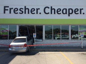 Police are on scene after a car crashed through the front of a grocery store Saturday, Aug. 22, 2015. (DAX MELMER / Windsor Star)