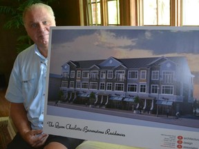 Gary Wellman shows a concept design of the Queen Charlotte Residences – six two-story townhomes above six commercial units – to be built in Amherstburg's historic downtown waterfront area. The building has a brownstone feel to it, typical in many large cities. (JULIE KOTSIS/The Windsor Star)