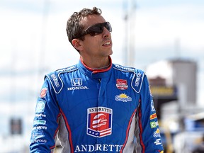 Justin Wilson, of England, walks on pit road during qualifying for Sunday's Pocono IndyCar 500 auto race, Saturday, Aug. 22, 2015, in Long Pond, Pa. Wilson was injured during Sunday's race and air lifted to the hospital. (AP Photo/Derik Hamilton)