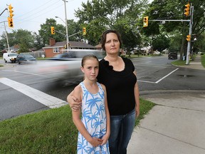 Cheri Bornais and her daughter Sophie, 9, are shown at the intersection of Dominion Blvd. and Labelle St. in South Windsor on Monday, August 10, 2015. They were almost hit by a car that jump a curb recently  while they were walking in the area. The family says it has become a dangerous intersection. (DAN JANISSE/The Windsor Star)