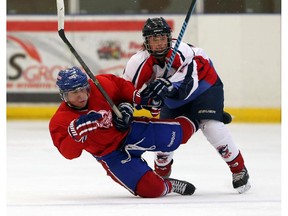 Lakeshore Canadiens Colin Sartor collides with Wheatley Sharks Eric Prudence in previous league play.