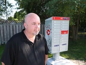 Rob McGuffin near a Canada Post mail box near his home in Tecumseh, Ontario.   McGuffin has concerns.  (JASON KRYK/The Windsor Star)
