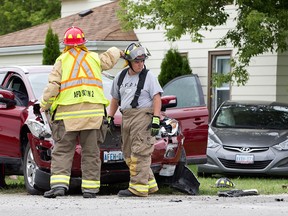 Emergency personal tend to a two-car motor vehicle collision at the intersection of North Side Rd., and 2nd Concession North, Saturday, August 8, 2015.  No serious injuries were reported.  (DAX MELMER/The Windsor Star)