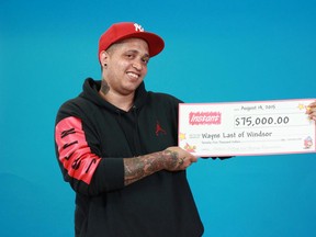 Wayne Last of Windsor displays his cheque for $75,000 at the OLG Price Centre in Toronto. (Courtesy of OLG)