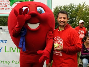 Kingsville Mayor Nelson Santos poses with the mascot of the Ruthven Apple Festival. Proceeds from the fest goes to help people in the county with intellectual disabilities.
- Courtesy Community Living Essex
