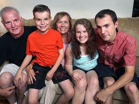 A Windsor family is trying to raise money on gofundme.com so they can buy eSight glasses to help three of their blind children see. Rod and Paula Rankin pose with their children Francis, 10, Tessa, 16, and Ian, 25, at their home on Thursday, Aug. 13, 2015.  (DAN JANISSE/The Windsor Star)