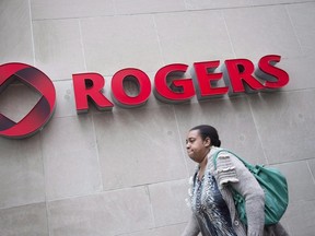 A pedestrian walks past the Rogers Building in Toronto on Tuesday, April 22, 2014. (THE CANADIAN PRESS/Darren Calabrese)