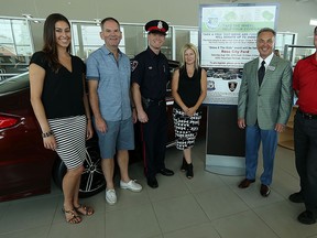 Lana Bezjak, Mike Clark, Andrew Drouillard, Tina Gatti John Chisholm and Bill Bevan (left to right) are photographed during a kick off event for Saturday's Drive 4 The Kids at Rose City Ford in Windsor on Friday, August 14, 2015. Ford will donate $20 for every test drive on Saturday. (TYLER BROWNBRIDGE/The Windsor Star)