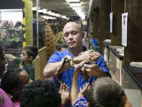 Tony Sabo shows day campers at the Canada South Science City a corn snake, Friday, August 28, 2015.