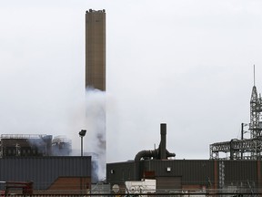 Smoke is shown at the bottom of the former General Motors smokestack on Monday, August 10, 2015, in Windsor, ON. after the third unsuccessful implosion attempt of the day. (DAN JANISSE/The Windsor Star)