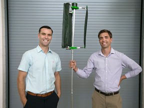 Lucas Semple, 28, and Kyle Bassett, 28, left, are pictured with a micro wind turbine they created and are now producing, Monday, August 3, 2015.   (DAX MELMER/The Windsor Star)