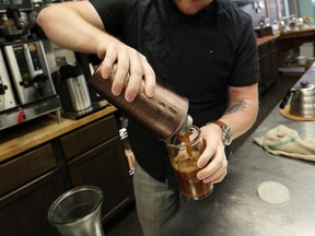Kyle Bondy serves up a cold brew coffee at Anchor Coffee House in Windsor on Friday, August 14, 2015. The brew process can take up to two days. (TYLER BROWNBRIDGE/The Windsor Star)