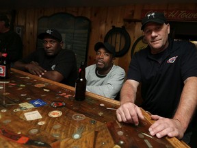 Kings Hotel owner Phil Towle (right) is photographed with his friends Mark (left) and Devon in the bar area of the hotel in Kingsville on Thursday, August 27, 2015. Towle, who insisted on being photographed with his companions, has been accused of refusing to serve a black man and woman from Michigan. The incident led the man to write a letter to town.                            (TYLER BROWNBRIDGE/The Windsor Star)