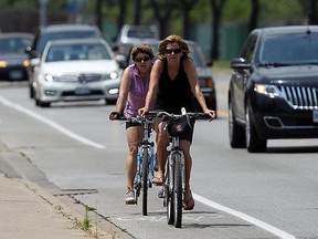 In this file photo, cyclists and cars are a common sight on Riverside Drive in Windsor on Monday, July 9, 2012. Recent talks about the proper place for e-bikes has some wondering about the rules of the roads and how they apply to cyclists.          (The Windsor Star / TYLER BROWNBRIDGE)