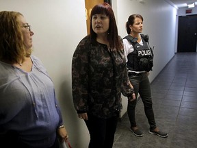 C.O.A.S.T. members Stephanie Bula, Ivanka Simeunovic and Windsor Police Constable Carol Bender check an apartment on Sandwich Street, Friday, Aug. 14, 2015.  (NICK BRANCACCIO/The Windsor Star)