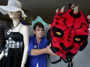 Deanne Miihlroth of Society Saint Vincent de Paul Thrift Store, prepares a back-to-school window display at the Chilver Road store Monday Aug. 17, 2015. The devilish-looking Star Wars backpack has a $4.50 price tag.  It is expected to sell quickly. (NICK BRANCACCIO/The Windsor Star)
