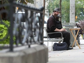 Andrew Nellis works Ouellette Avenue as a tarot card reader. He’s also part of a group of panhandlers called Street Labourers Of Windsor, or SLOW, which is under the banner of the Industrial Workers of the World, a radical labour union formed in 1905. (JASON KRYK / The Windsor Star)