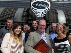 Toon Dreessen, centre, president of Ontario Association of Architects, poses with Allaa Mokdad, left, a recent graduate from Lawrence Tech and Krista Doyle, right, OAA executive director and about 20 other local architects at Lorelei's Bistro on Wyandotte Street East on Wednesday, Aug. 19, 2015. (NICK BRANCACCIO / The Windsor Star)