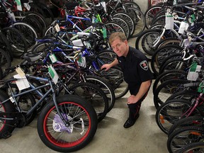 Surrounded by hundreds of recoverd bicylces, Const. Andrew Drouillard in Property and Evidence Retention Unit at Windsor Police headquarters September 3, 2015.  (NICK BRANCACCIO/The Windsor Star)