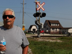 Vince Renaud and other residents of Couture Beach are concerned about freight trains which thunder just a few metres from their homes on Couture Beach Road on Thursday, Sept. 3, 2015.  Renaud's home is shown at right. (NICK BRANCACCIO/The Windsor Star)