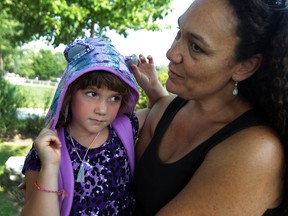 Saige Cowan, 6, is held by her mother Marleen Payne at Percy P. McCallum Elementary School Tuesday, Sept. 8, 2015.  (NICK BRANCACCIO/The Windsor Star)