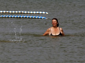 Lou McKeon, left, shows a synchro swimming move with friend Denise Lanoue at Sandpoint Beach Sept. 8, 2015. Extremely hot temperatures and high humidity made for uncomfortable conditions for some students heading back to school, but those at Sandpoint were refreshed by the waters of Lake St. Clair. (NICK BRANCACCIO/The Windsor Star)