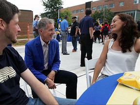 University President Alan Wildeman, centre, chats with masters students Frederik Ehlen, left, and Kathrin Holzhauer during University of Windsor annual community barbeque to welcome students back, Wednesday Sept. 9, 2015.  (NICK BRANCACCIO/The Windsor Star)