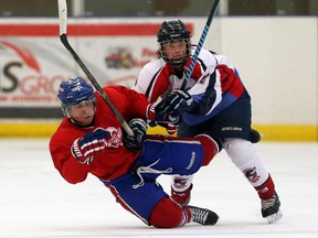 Lakeshore Canadiens Colin Sartor collides with Wheatley Omstead Sharks Eric Prudence in a Great Lakes Junior C exhibition game in Lakeshore, Ont., last month. (JASON KRYK/The Windsor Star)