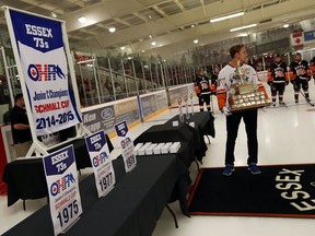 The Essex 73's Scott Bromley carries the trophy as the team unveils the Schmalz Cup championship banner prior to the season opener in Essex on Tuesday, Sept. 8, 2015. (TYLER BROWNBRIDGE/The Windsor Star)