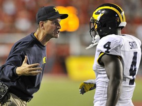 Head coach Jim Harbaugh of the Michigan Wolverines gestures to his player De'Veon Smith #4 late during their 24-17 loss to the Utah Utes at Rice-Eccles Stadium on September 3, 2015 in Salt Lake City, Utah. (Photo by Gene Sweeney Jr/Getty Images)